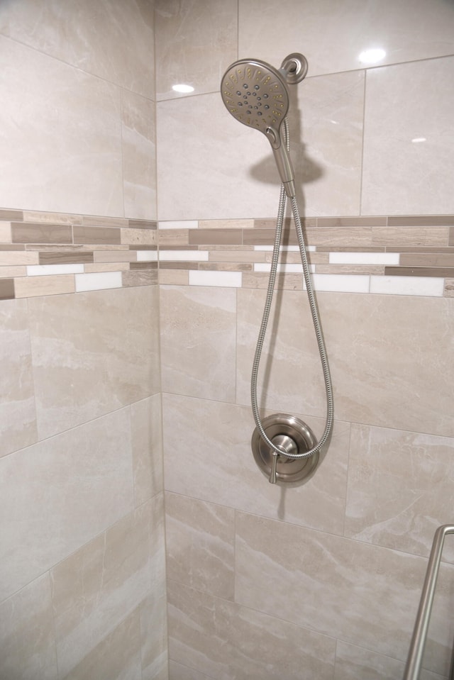 interior details featuring a tile shower