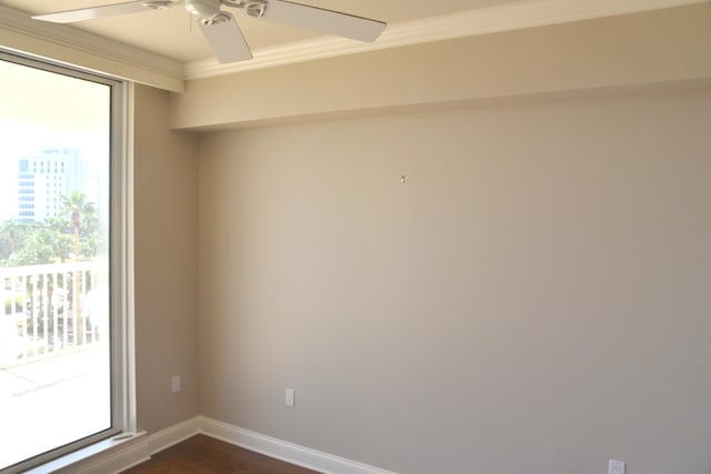 empty room with crown molding, ceiling fan, and dark hardwood / wood-style floors