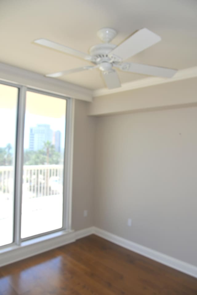 unfurnished room featuring ceiling fan and dark wood-type flooring