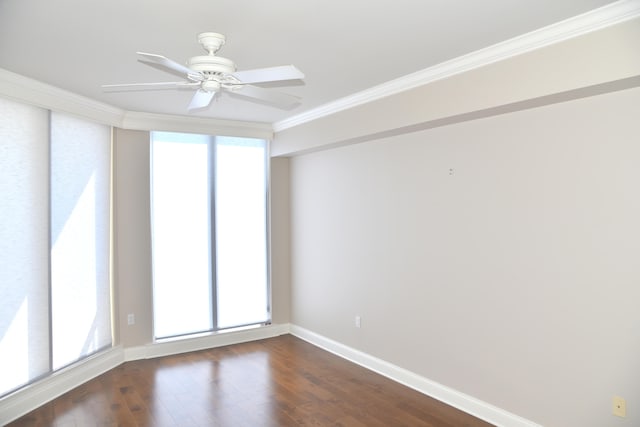 empty room featuring ornamental molding, dark hardwood / wood-style flooring, a wealth of natural light, and ceiling fan