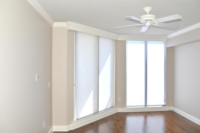 unfurnished room with ceiling fan, crown molding, and dark wood-type flooring