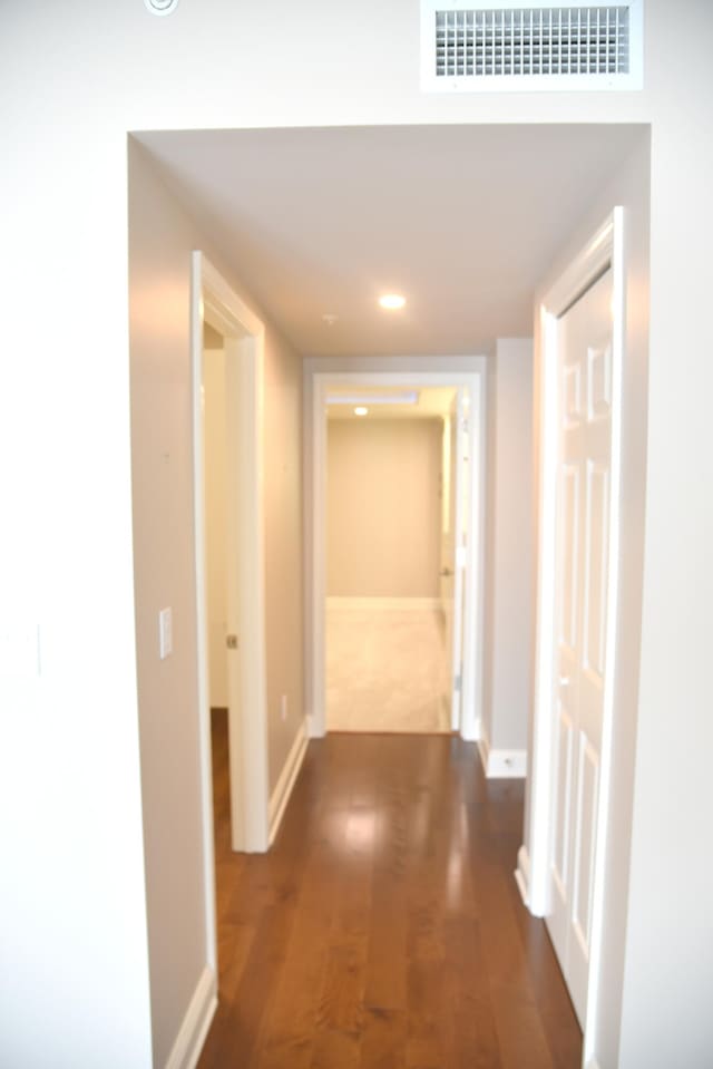 corridor featuring dark hardwood / wood-style flooring