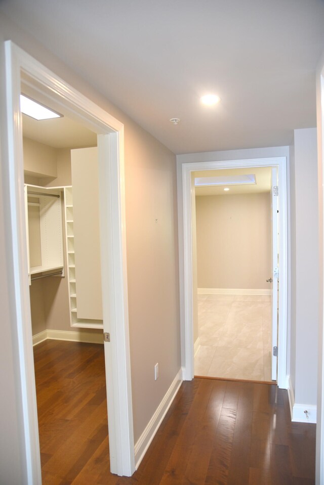 corridor with wood-type flooring