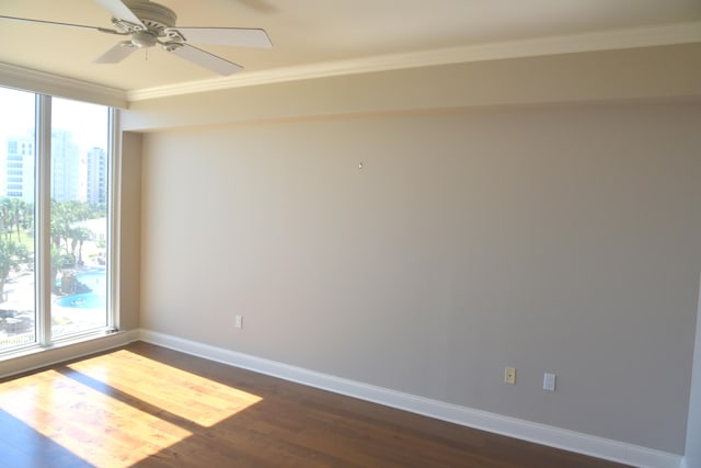 spare room with ornamental molding, ceiling fan, and dark hardwood / wood-style floors