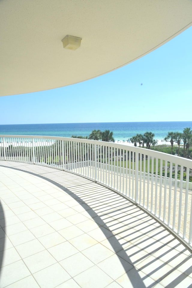 balcony featuring a beach view and a water view