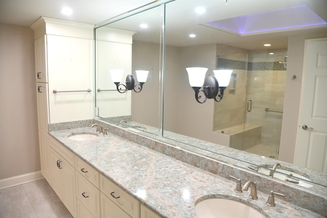 bathroom with vanity, an enclosed shower, and tile patterned floors