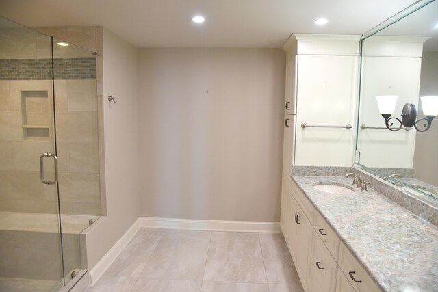 bathroom featuring walk in shower, tile patterned floors, and vanity