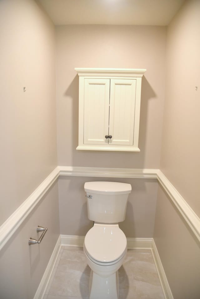 bathroom with tile patterned flooring and toilet