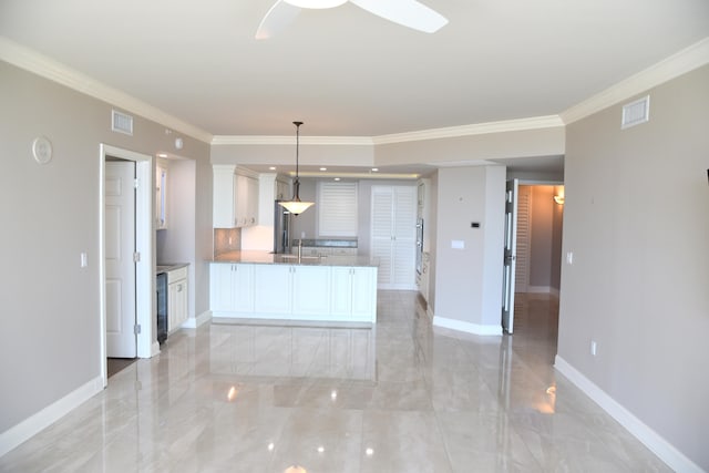 kitchen with ceiling fan, crown molding, decorative light fixtures, wine cooler, and white cabinets