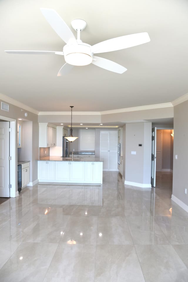 unfurnished living room featuring crown molding and ceiling fan