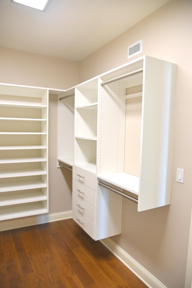 spacious closet with dark hardwood / wood-style floors