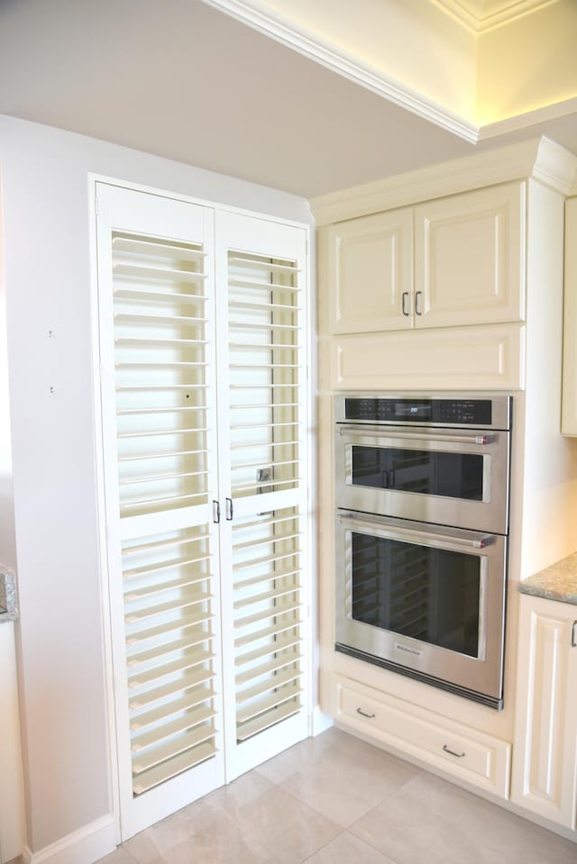 kitchen with light tile patterned flooring and double oven