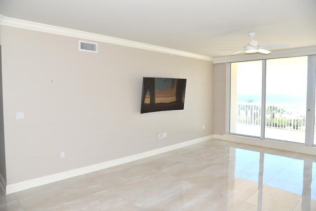 tiled spare room with ornamental molding and ceiling fan