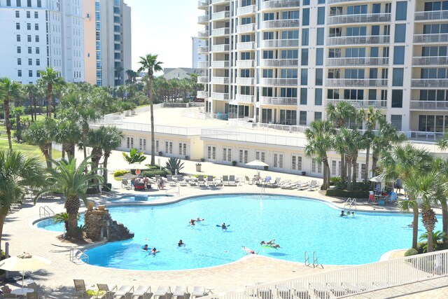 15400 Emerald Coast Pkwy Unit 406, Destin, FL 32541 - community pool featuring a patio area