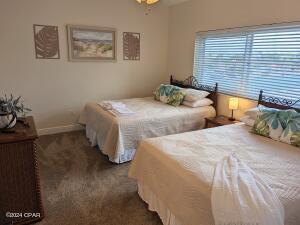 6415 Thomas Dr Unit 205, Panama City Beach, FL 32408 - carpeted bedroom with baseboards and ceiling fan