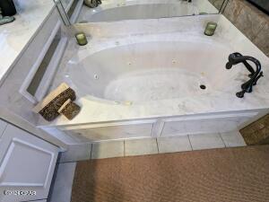 6415 Thomas Dr Unit 205, Panama City Beach, FL 32408 - full bath featuring a jetted tub and tile patterned floors