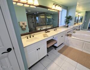 bathroom featuring shower with separate bathtub, tile patterned flooring, and vanity