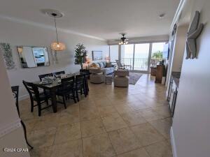 dining space with ceiling fan and tile patterned floors