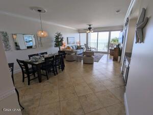 6415 Thomas Dr Unit 205, Panama City Beach, FL 32408 - dining room with a ceiling fan, crown molding, and light tile patterned flooring