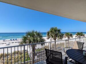 6415 Thomas Dr Unit 205, Panama City Beach, FL 32408 - balcony with view of water and beach and outdoor dining area