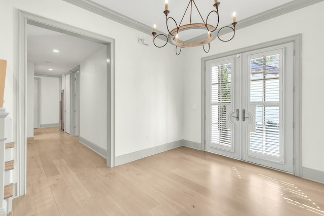 interior space with french doors, ornamental molding, a notable chandelier, and light hardwood / wood-style floors