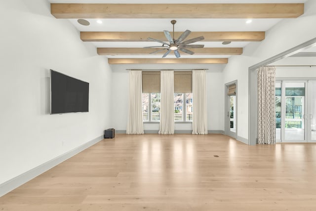 unfurnished living room with ceiling fan, beamed ceiling, light wood-type flooring, and french doors