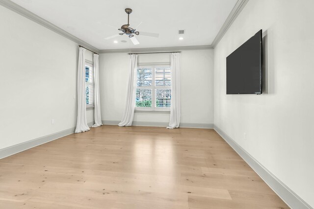 empty room featuring ceiling fan, light hardwood / wood-style flooring, and crown molding