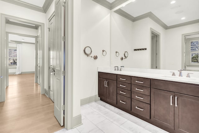 bathroom with vanity, crown molding, and hardwood / wood-style floors