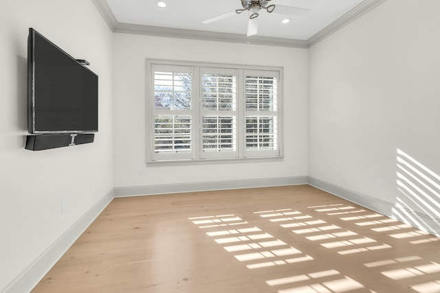 empty room with crown molding, light hardwood / wood-style floors, and ceiling fan