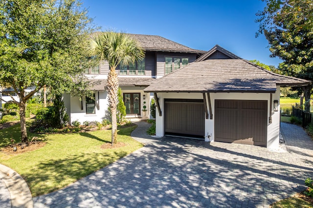 view of front facade featuring a front yard and a garage