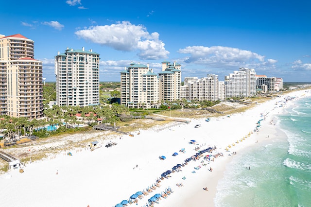 birds eye view of property featuring a water view and a beach view