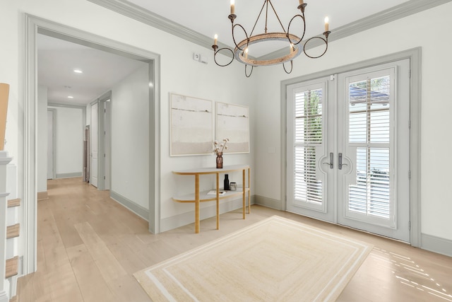 doorway to outside featuring light wood-type flooring, crown molding, french doors, and a notable chandelier