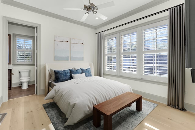 bedroom featuring ceiling fan, connected bathroom, light wood-type flooring, and crown molding