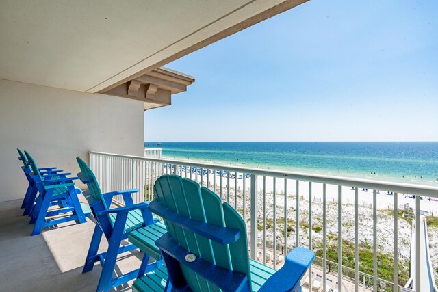 balcony with a water view and a beach view