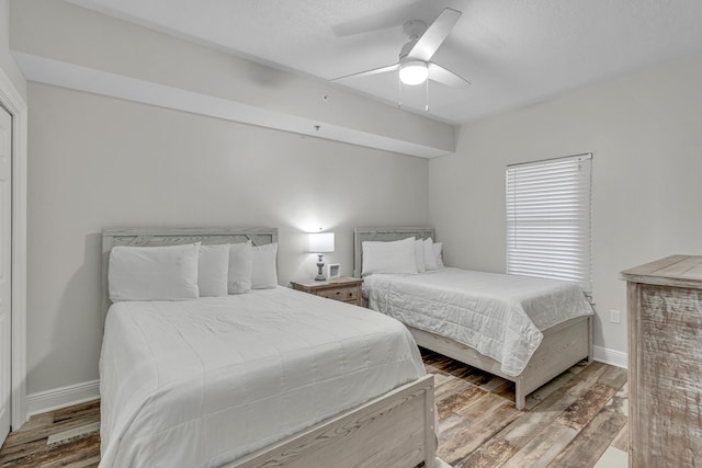 bedroom featuring wood-type flooring and ceiling fan