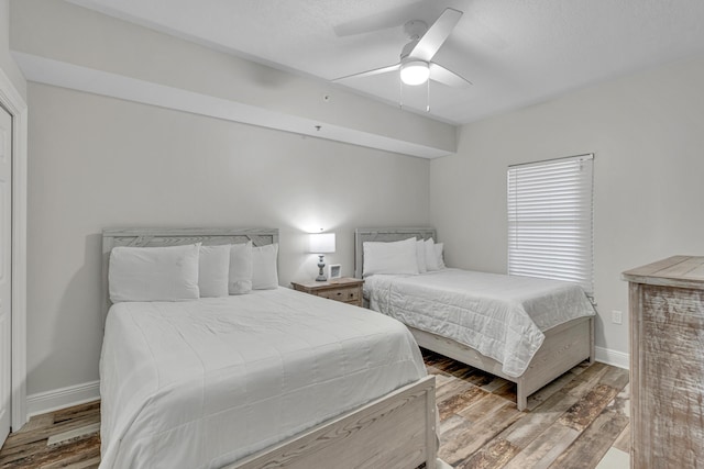 1111 Santa Rosa Blvd Unit 604, Fort Walton Beach, FL 32548 - bedroom with baseboards, wood finished floors, and ceiling fan