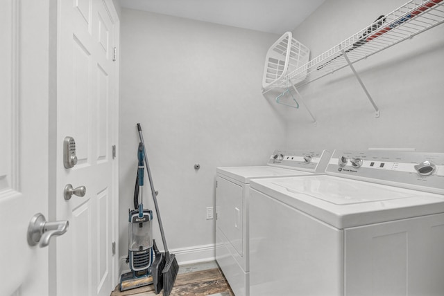 laundry area with hardwood / wood-style floors and washer and dryer