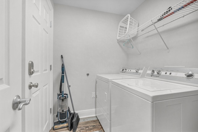 1111 Santa Rosa Blvd Unit 604, Fort Walton Beach, FL 32548 - laundry room featuring dark wood-style floors, separate washer and dryer, laundry area, and baseboards