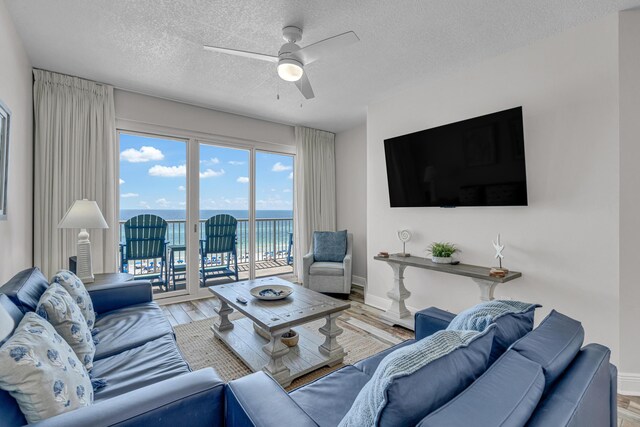 1111 Santa Rosa Blvd Unit 604, Fort Walton Beach, FL 32548 - living area with a ceiling fan, a textured ceiling, baseboards, and wood finished floors