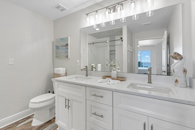 1111 Santa Rosa Blvd Unit 604, Fort Walton Beach, FL 32548 - ensuite bathroom featuring toilet, a sink, a stall shower, and visible vents