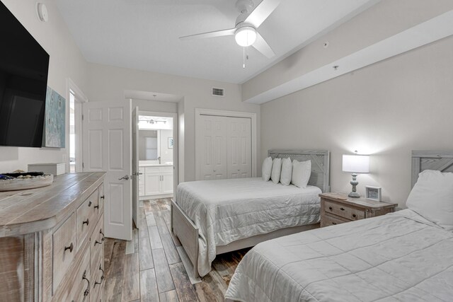 1111 Santa Rosa Blvd Unit 604, Fort Walton Beach, FL 32548 - bedroom featuring a closet, a ceiling fan, wood finished floors, ensuite bathroom, and visible vents