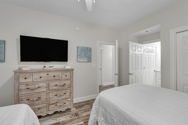 bedroom with ceiling fan and hardwood / wood-style flooring