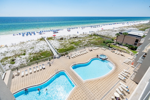 bird's eye view featuring a water view and a beach view