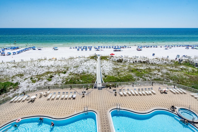 bird's eye view featuring a water view and a view of the beach