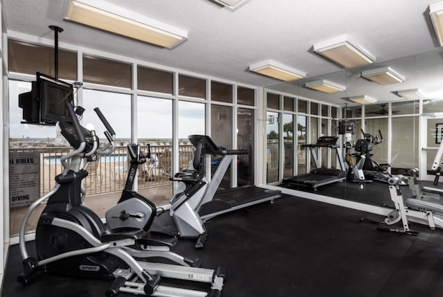 1111 Santa Rosa Blvd Unit 604, Fort Walton Beach, FL 32548 - workout area with a wall of windows and a textured ceiling