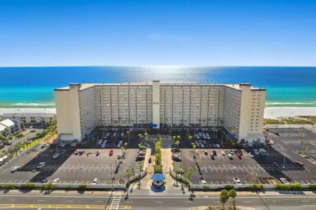 drone / aerial view featuring a water view and a beach view