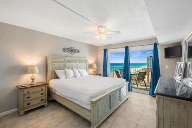 bedroom with ceiling fan, access to exterior, and light tile patterned floors