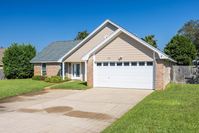 view of front of property featuring a front yard and a garage