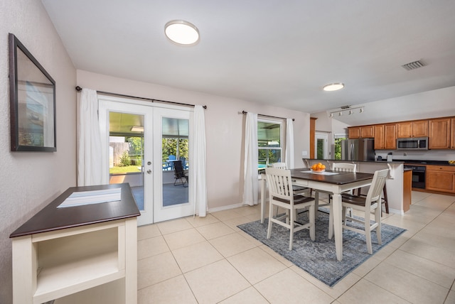 dining room with french doors and light tile patterned floors