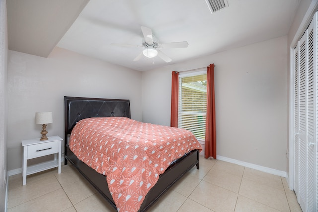 tiled bedroom with a closet and ceiling fan